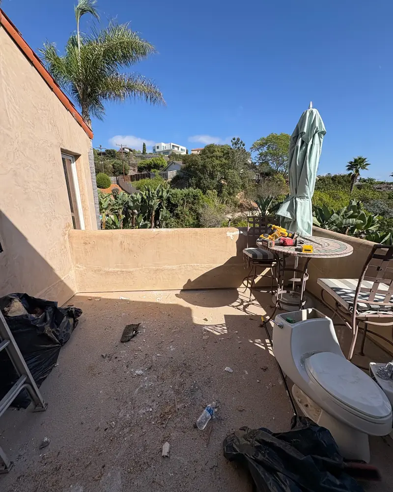 After: the same balcony cleared of all lumber and debris, with patio furniture back in use